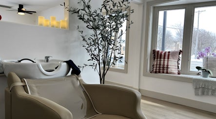 Relaxing wash station at RèFINE Boutique Salon in Morton Grove, Illinois, US, with window views and cozy decor.
