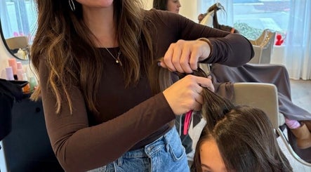 Stylist crafting a chic hairdo at RèFINE Boutique Salon, Morton Grove, Illinois, US.