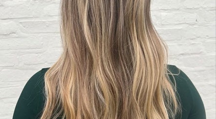 Blonde hair styled at RèFINE Boutique Salon in Morton Grove, Illinois, US, showcasing soft waves and highlights.