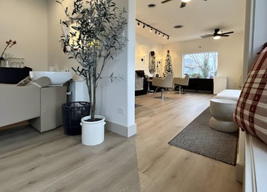 Modern interior of RèFINE Boutique Salon in Morton Grove, Illinois, US, showcasing chic and comfortable seating.