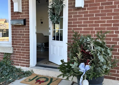Inviting entryway of RèFINE Boutique Salon in Morton Grove, Illinois, US with festive decor and open door.