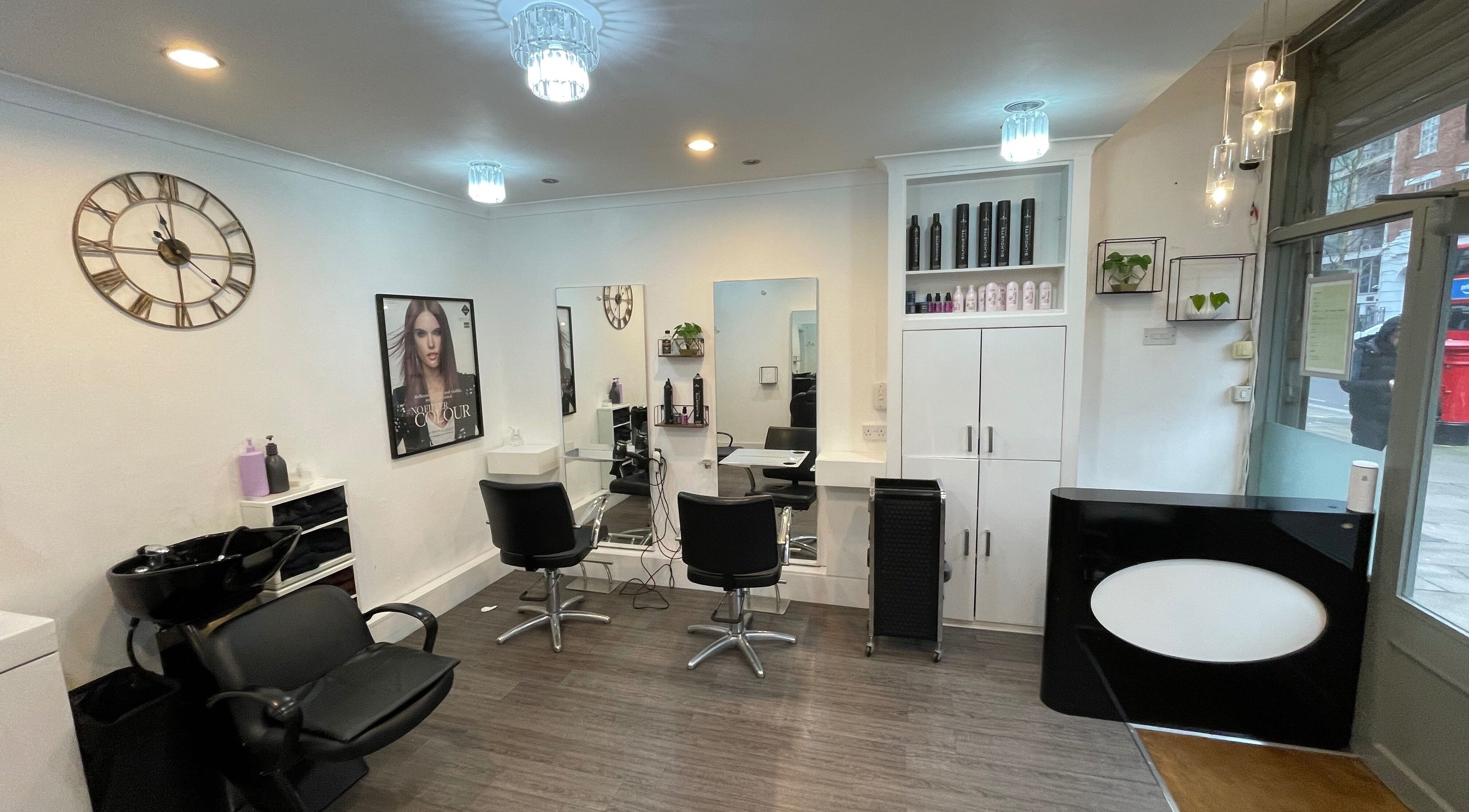 Modern interior of The Cut Studio (Hair) in London, England, GB. Featuring styling chairs and sleek decor.