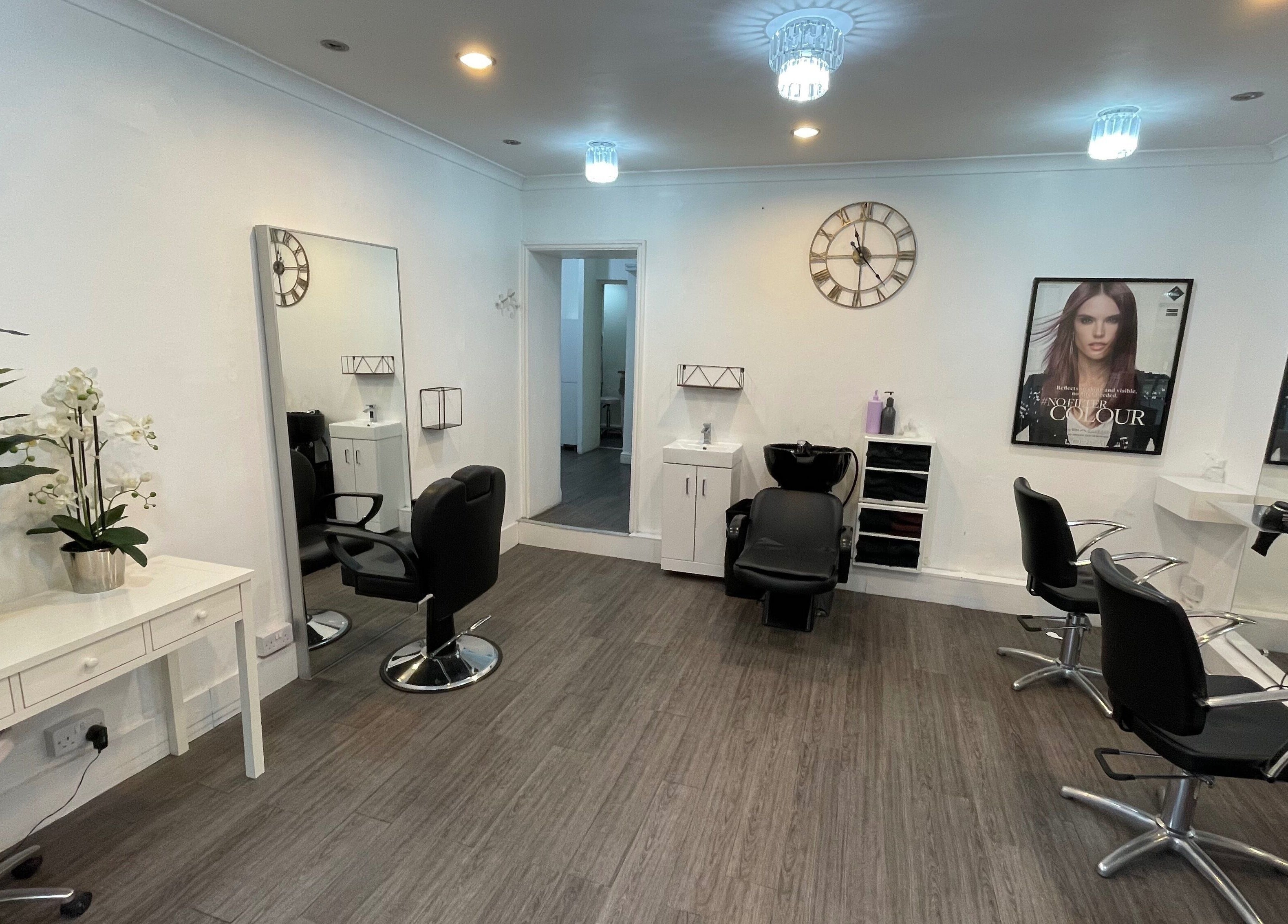 Modern salon interior at The Cut Studio (Hair) in London, England, GB with stylish chairs and decor.