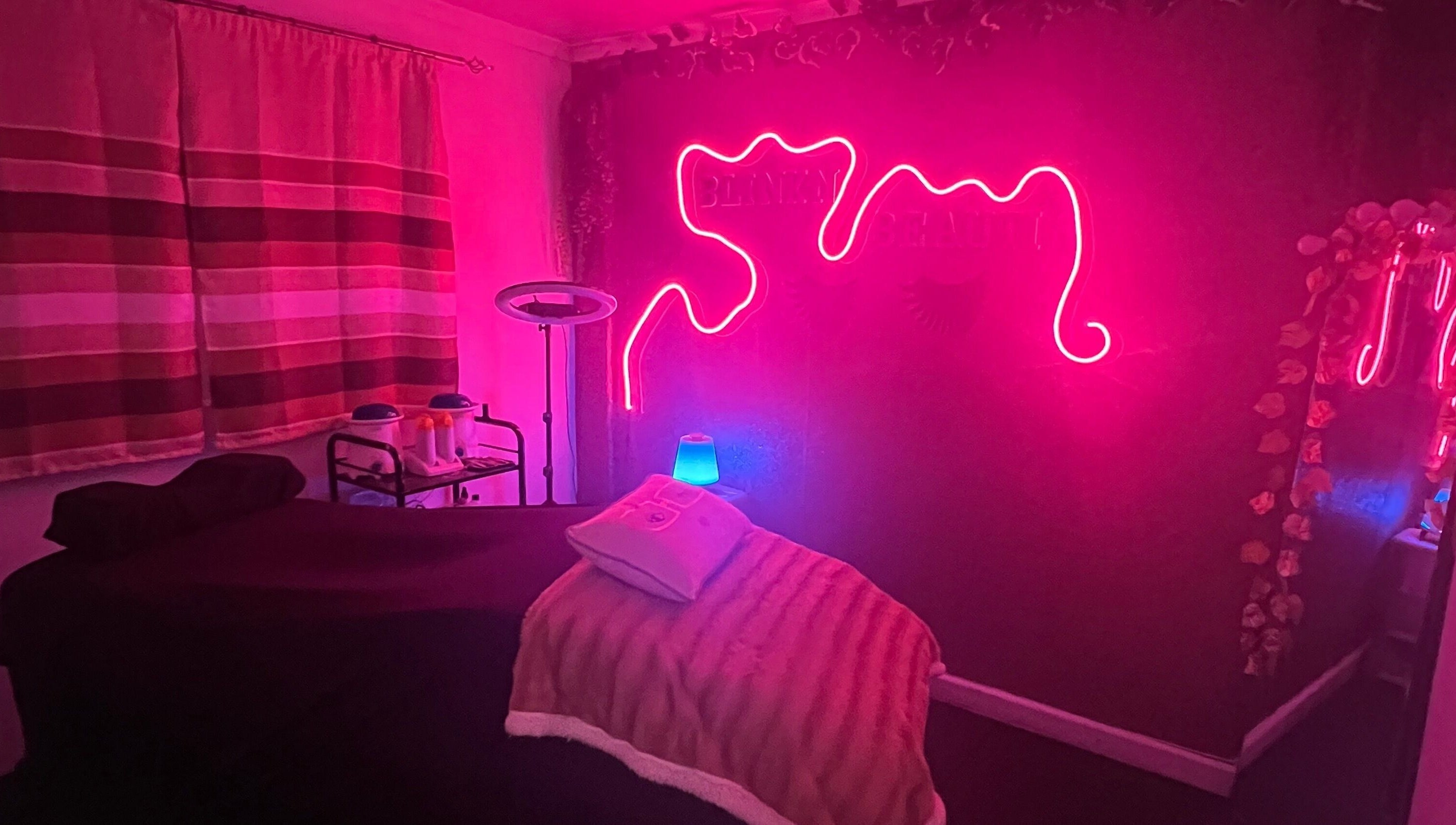 Cozy treatment room with neon lights at Blink'n Beauti, Cape Town, Western Cape, ZA.