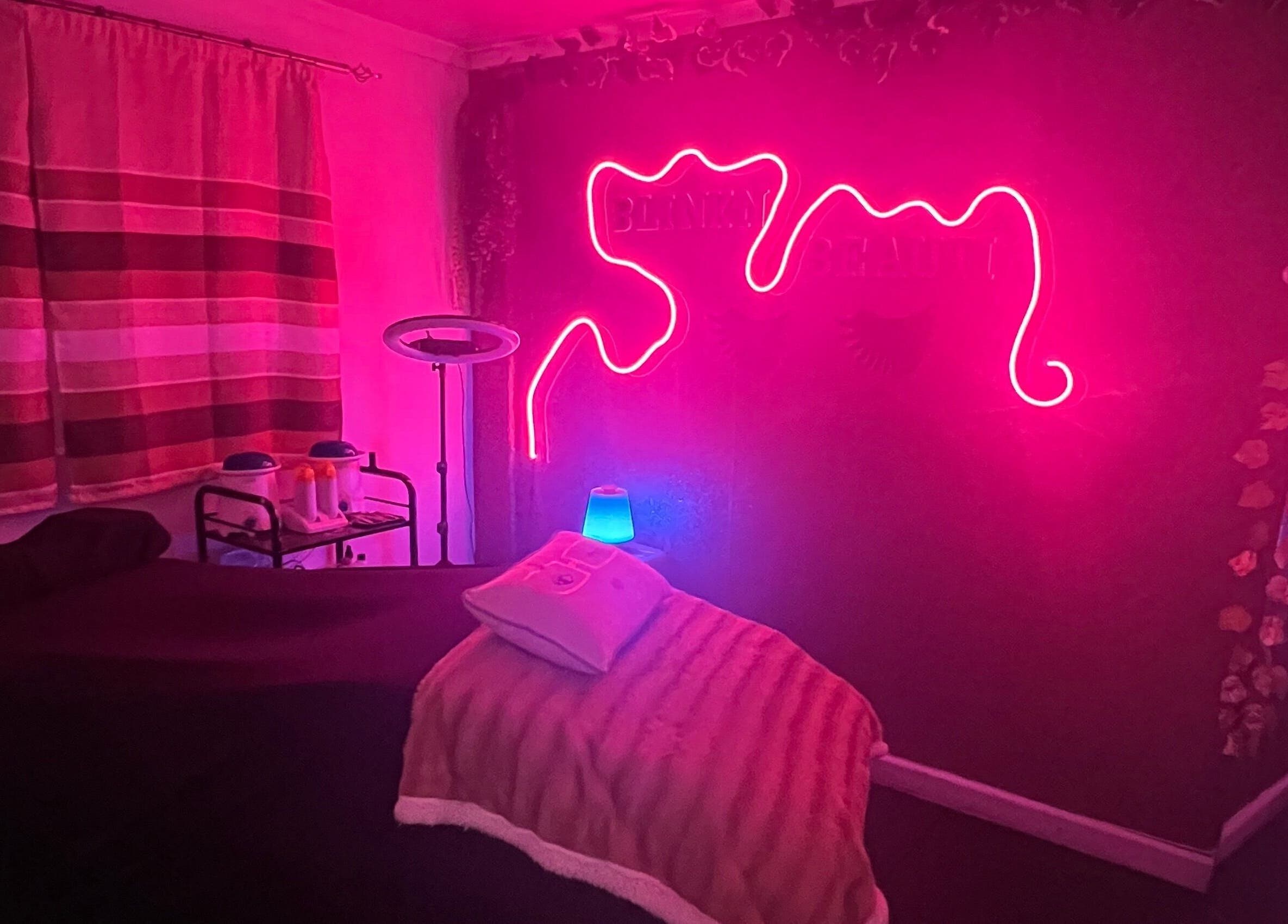 Cozy treatment room with neon lights at Blink'n Beauti, Cape Town, Western Cape, ZA.