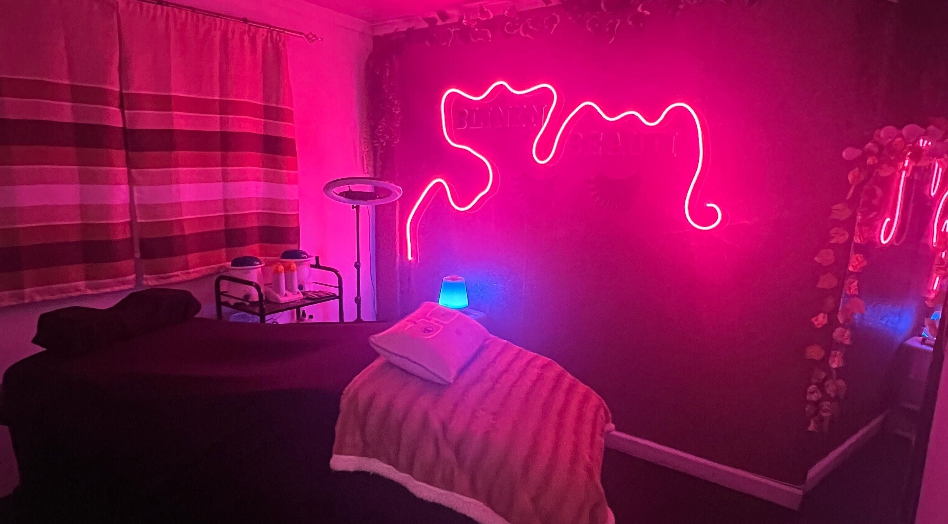 Cozy treatment room with neon lights at Blink'n Beauti, Cape Town, Western Cape, ZA.