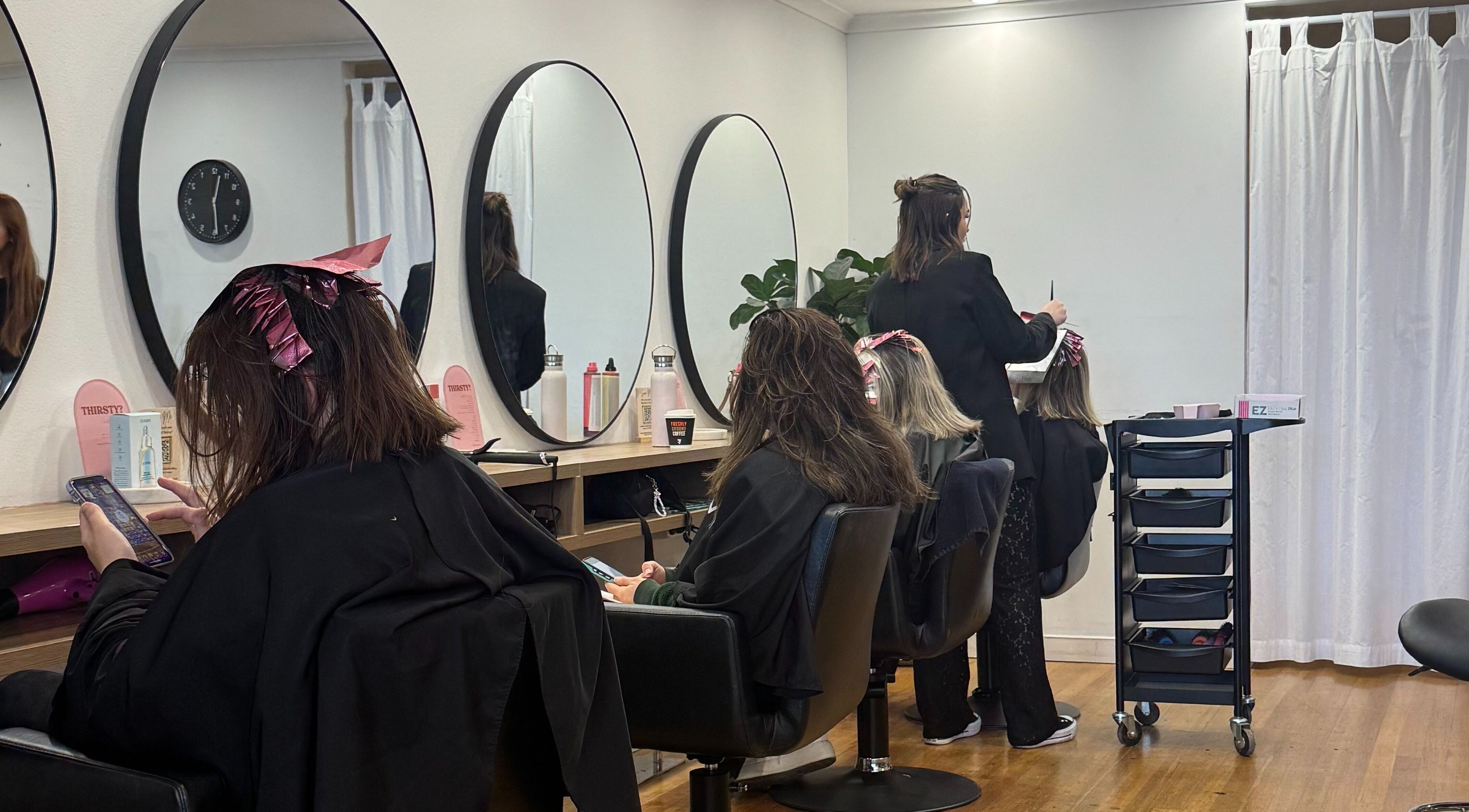 Clients getting hair treatments at Becca Hair and Beauty in Melbourne, Victoria, AU.