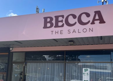 Entrance of Becca Hair and Beauty in Melbourne, Victoria, AU with a pink signboard.