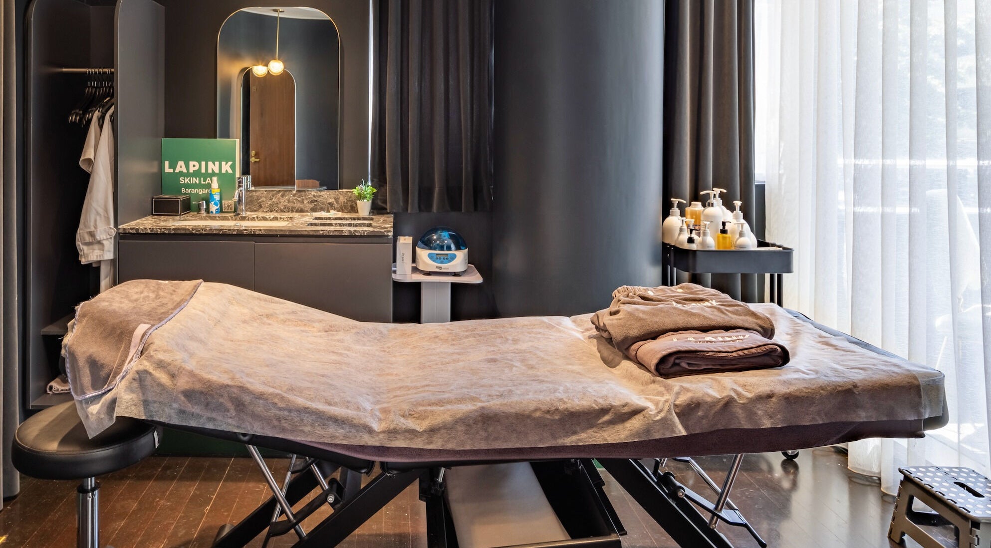 Luxurious treatment room at Lapink Skin Lab, Barangaroo, New South Wales, AU. Tranquil spa with cozy linens.
