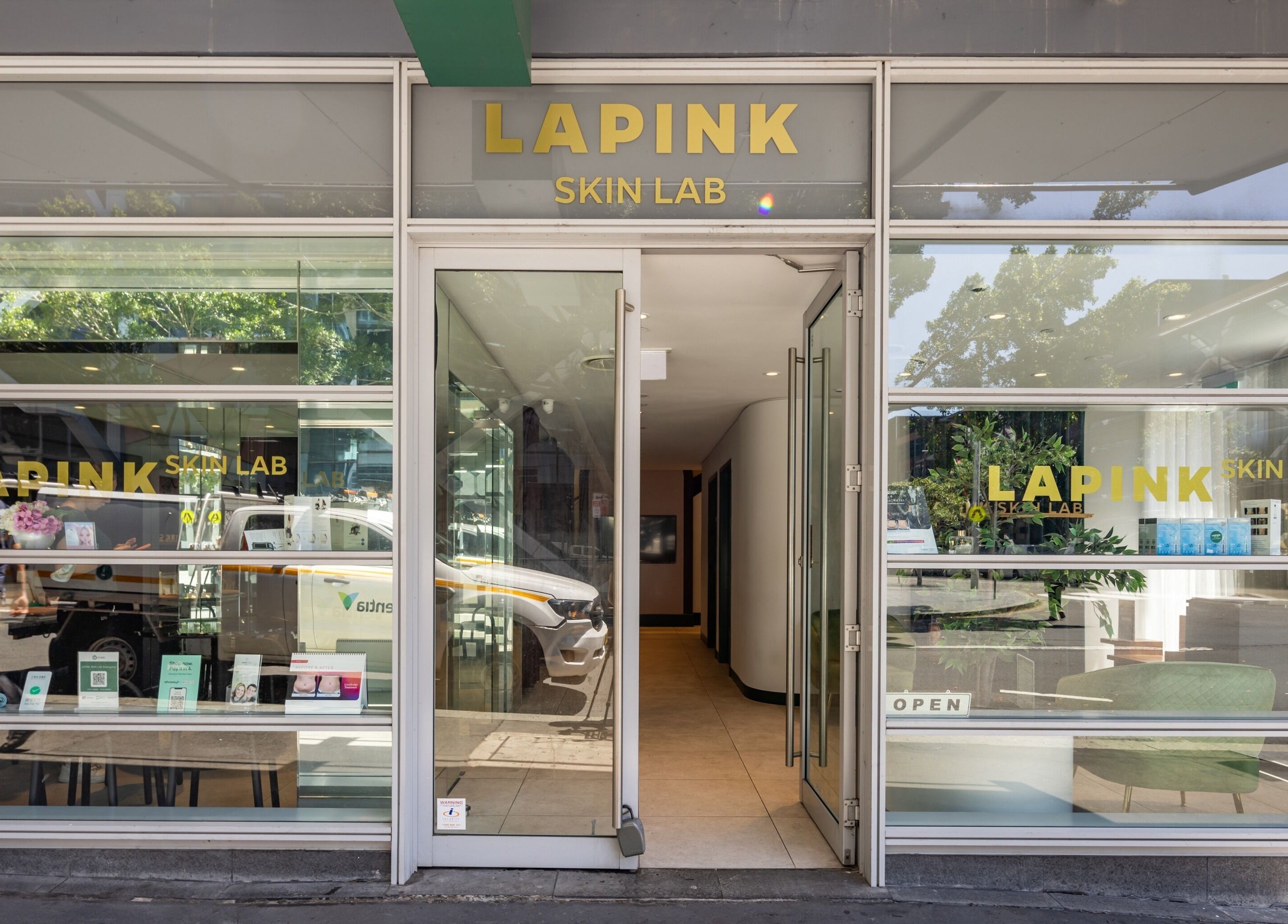Entrance of Lapink Skin Lab at Barangaroo, New South Wales, AU, showcasing modern glass design.