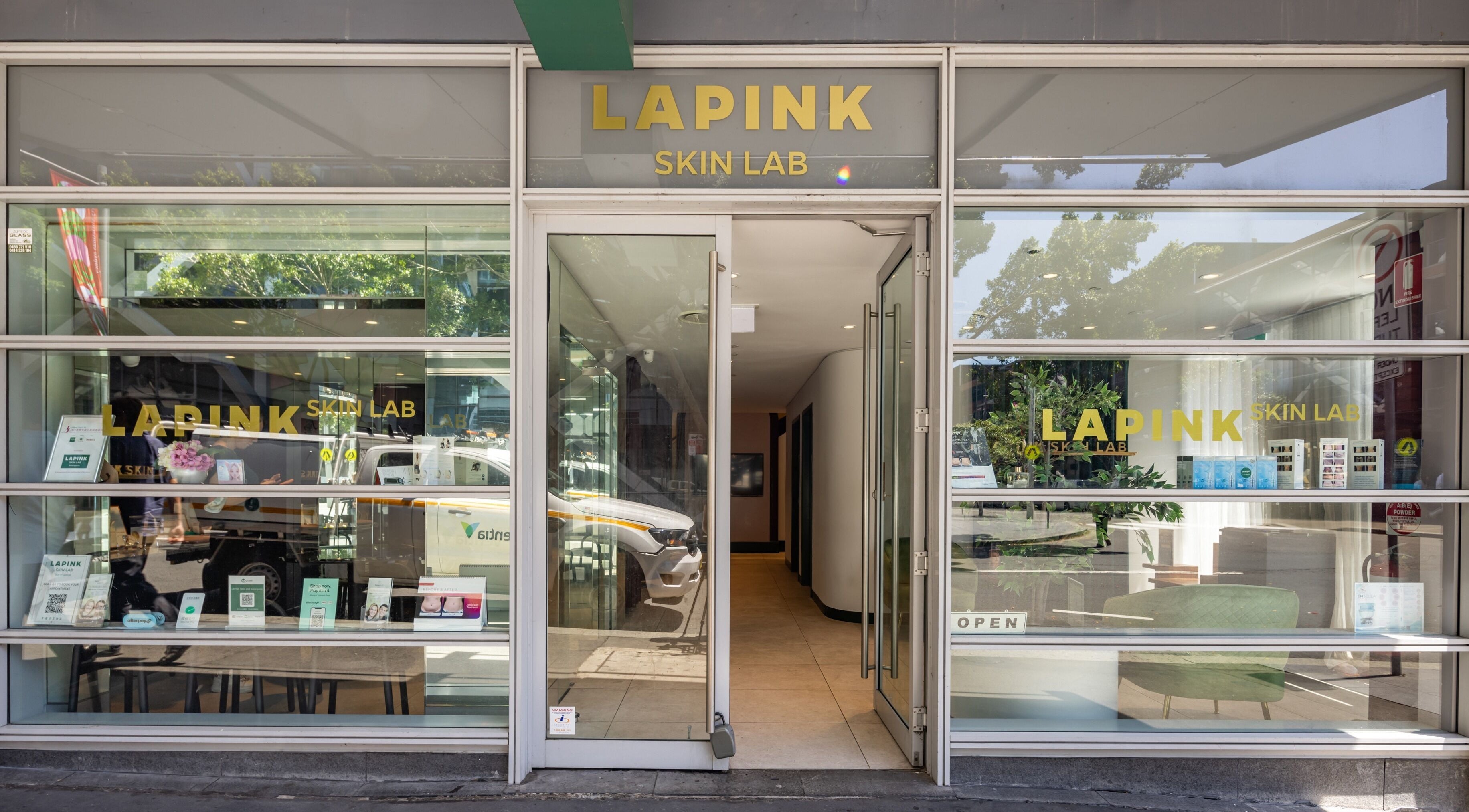 Entrance of Lapink Skin Lab at Barangaroo, New South Wales, AU, showcasing modern glass design.