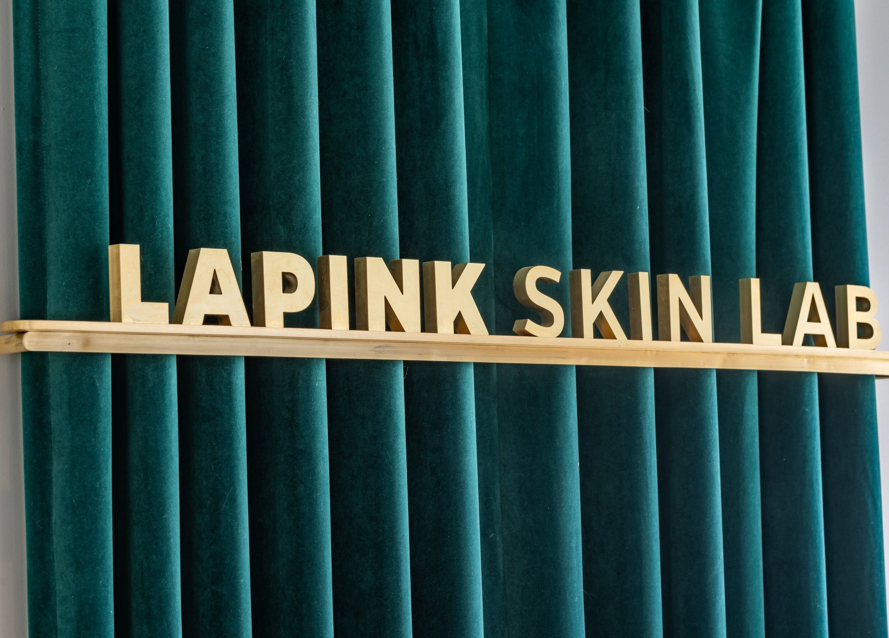 Lapink Skin Lab signage on teal curtain at Barangaroo, New South Wales, AU.