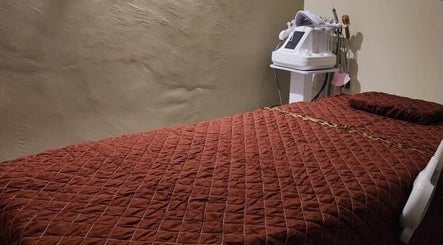 Massage room at Awa Salon and Spa, Tumpat, Kelantan, MY, featuring a relaxing brown treatment bed.