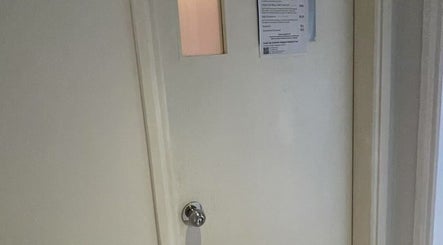 Entrance door to M Nails SG in Singapore, SG, featuring a sleek design and informational signage.