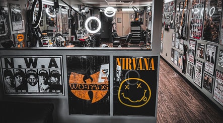 Interior of Barber’s Choice Studio in Oakdale, Minnesota, US, featuring music band posters and styling stations.