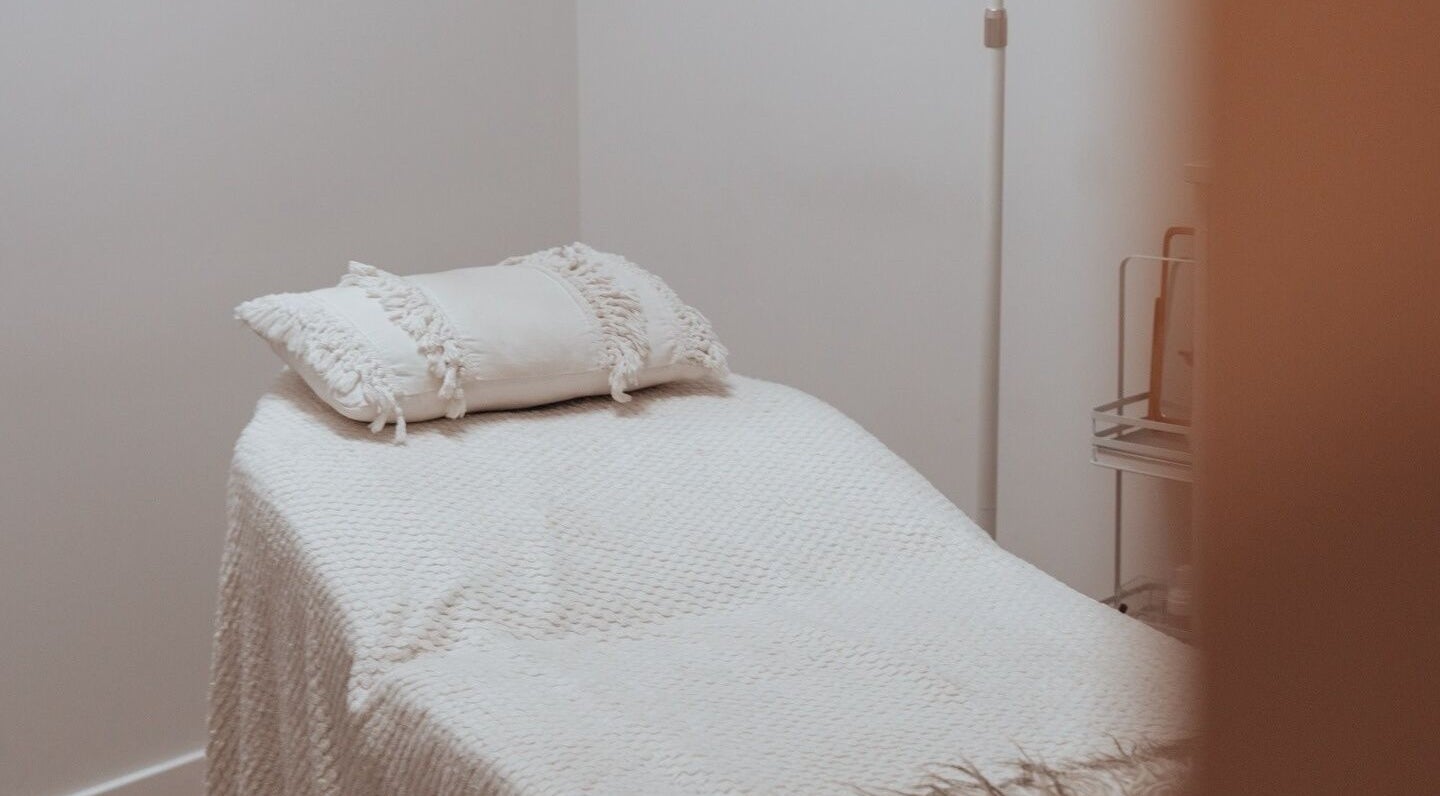 Serene massage room at The Beauty Collective Cairns, located in Cairns City, Queensland, AU, featuring a comfy bed.