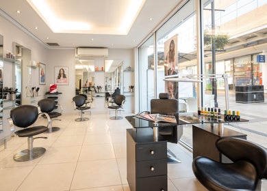 Interior of Vida hair & beauty The Brewery, Romford, England, GB, featuring sleek salon chairs and modern decor.