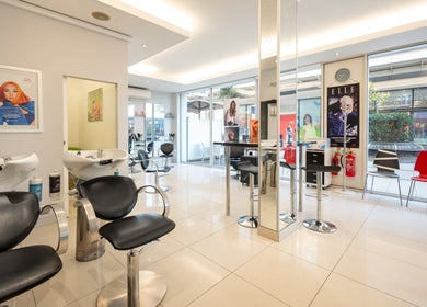 Modern salon interior at Vida hair & beauty The Brewery, Romford, England, GB, with stylish chairs and decor.