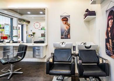 Modern salon interior at Vida Hair & Beauty The Mercury, Romford, England, GB. Sleek chairs and stylish decor.