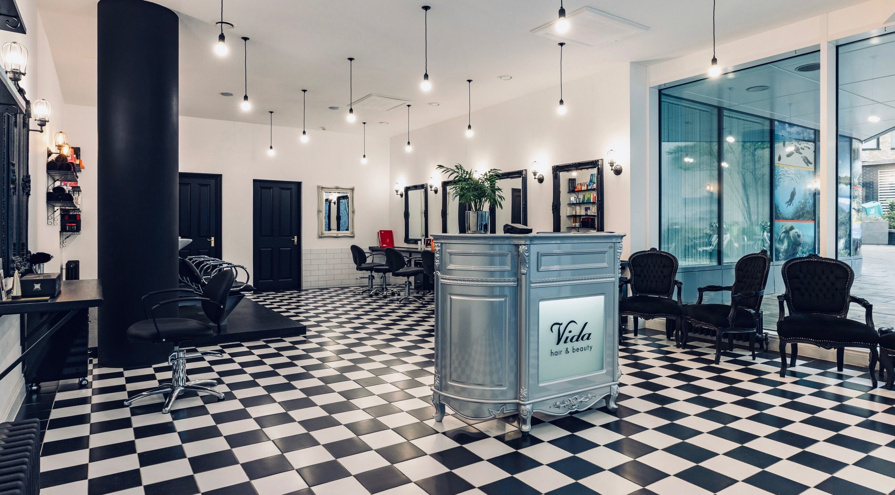 Chic interior of Vida hair & beauty Aldgate salon, London, England, GB with stylish decor and seating.