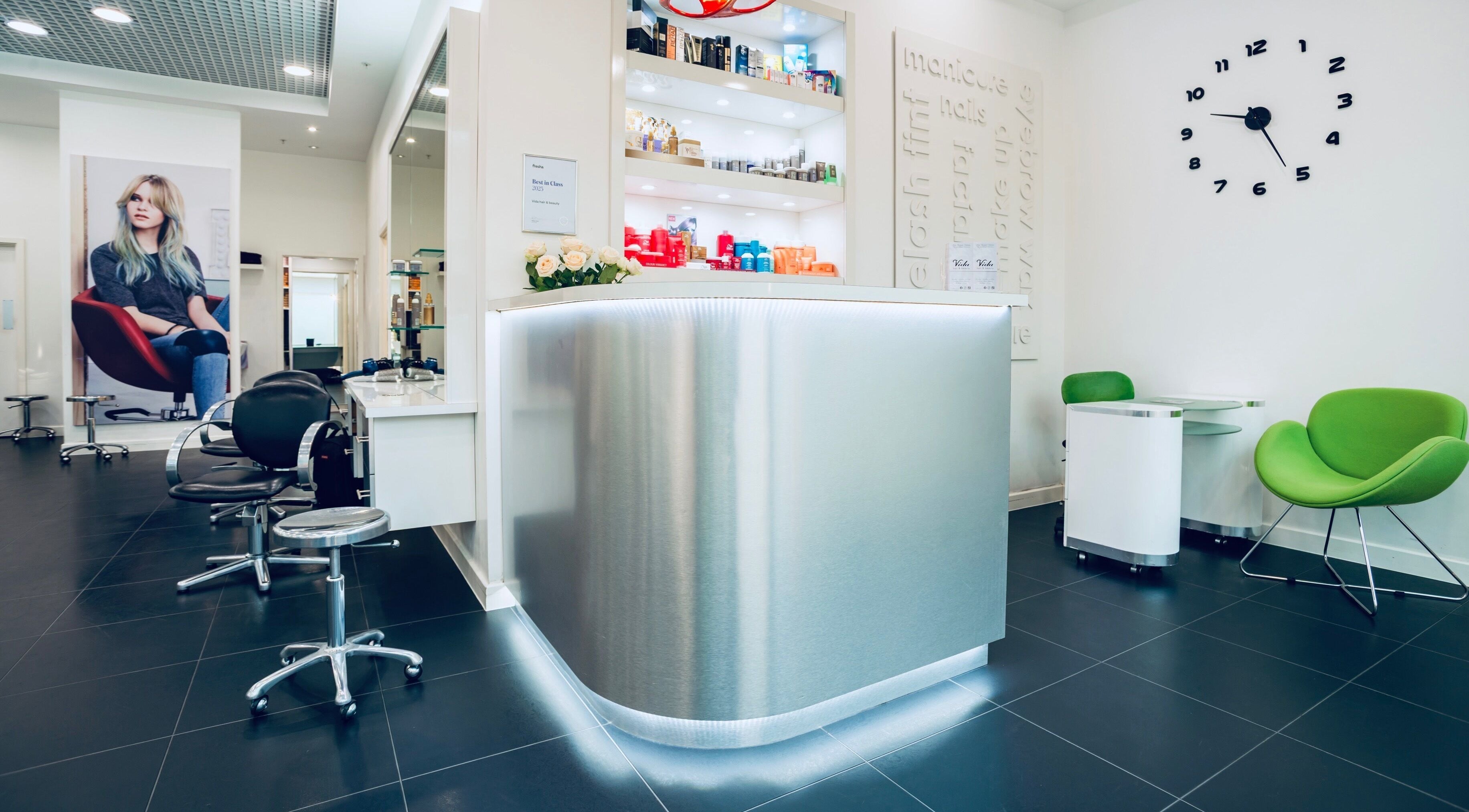 Elegant interior of Vida hair & beauty Ilford, showcasing stylish chairs and modern decor in Ilford, England, GB.