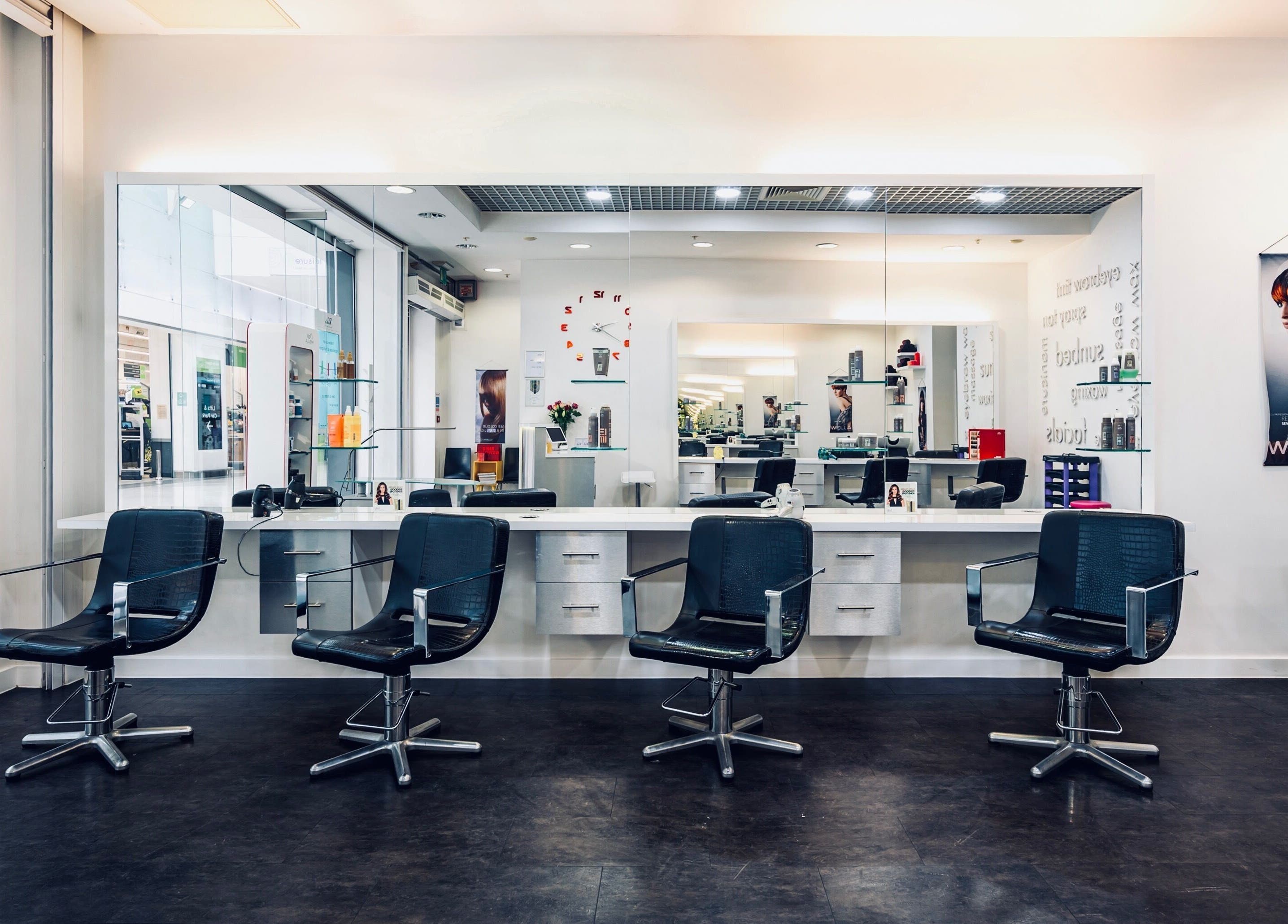 Modern salon chairs and mirrored stations at Vida Hair & Beauty The Mercury in Romford, England, GB.
