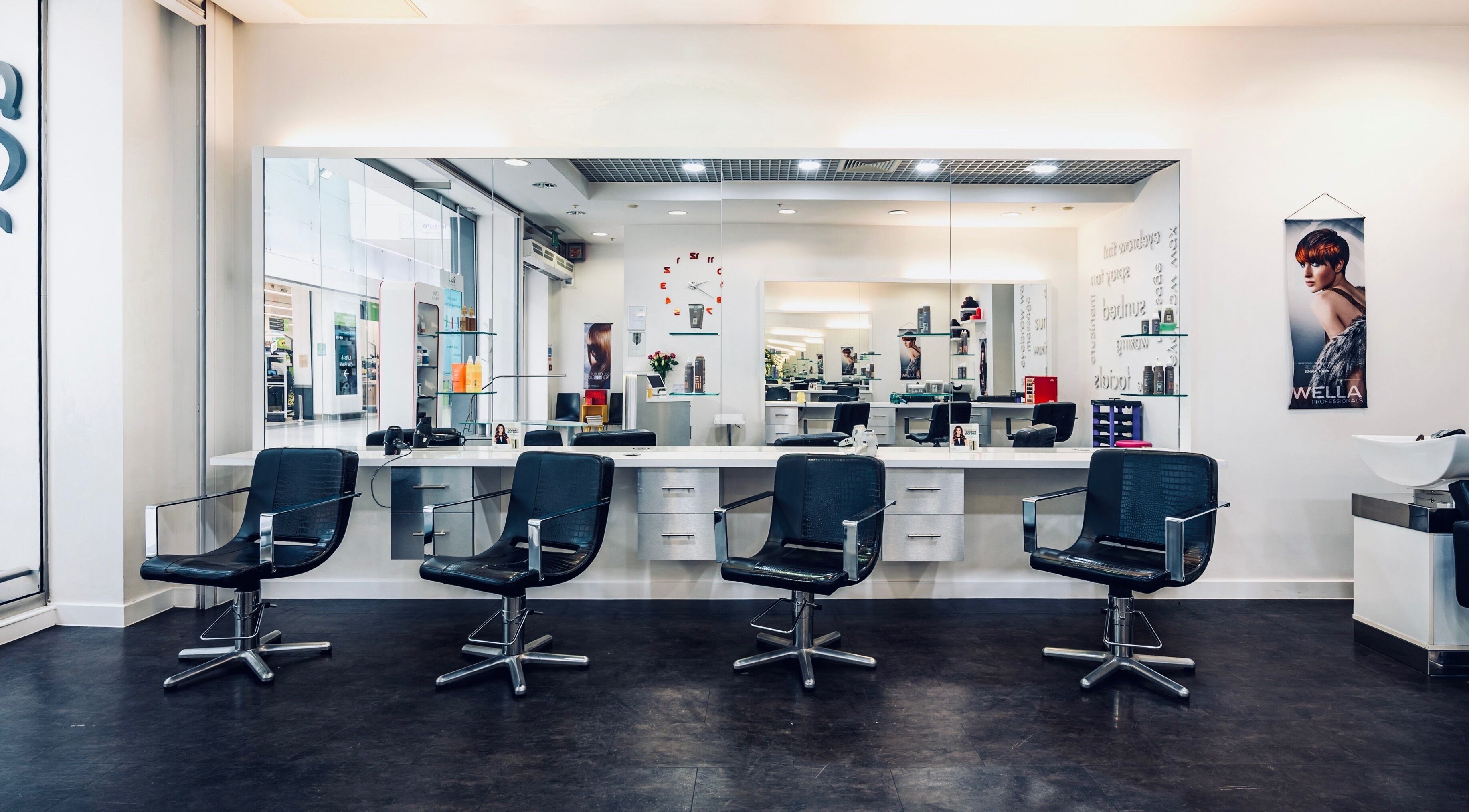 Modern salon chairs and mirrored stations at Vida Hair & Beauty The Mercury in Romford, England, GB.