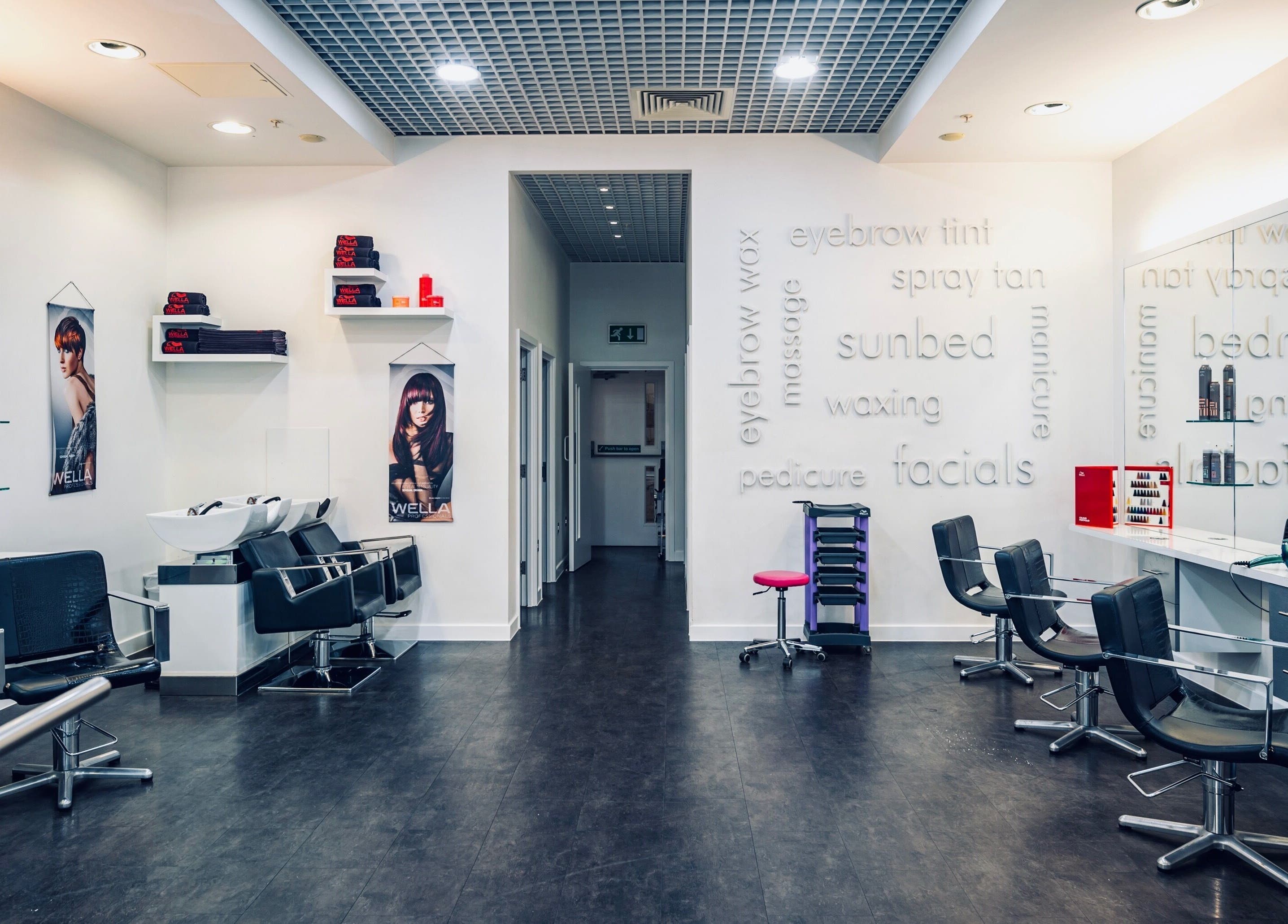 Modern interior of Vida Hair & Beauty The Mercury in Romford, England, GB with stylish salon chairs and mirrors.