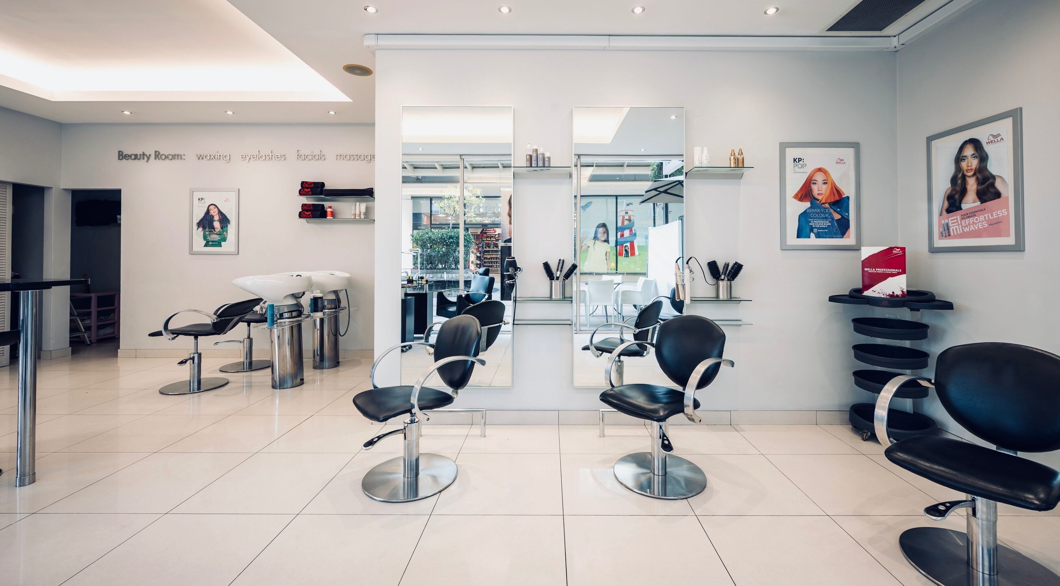 Modern interior of Vida hair & beauty The Brewery, Romford, England, GB, showcasing sleek salon chairs and mirrors.