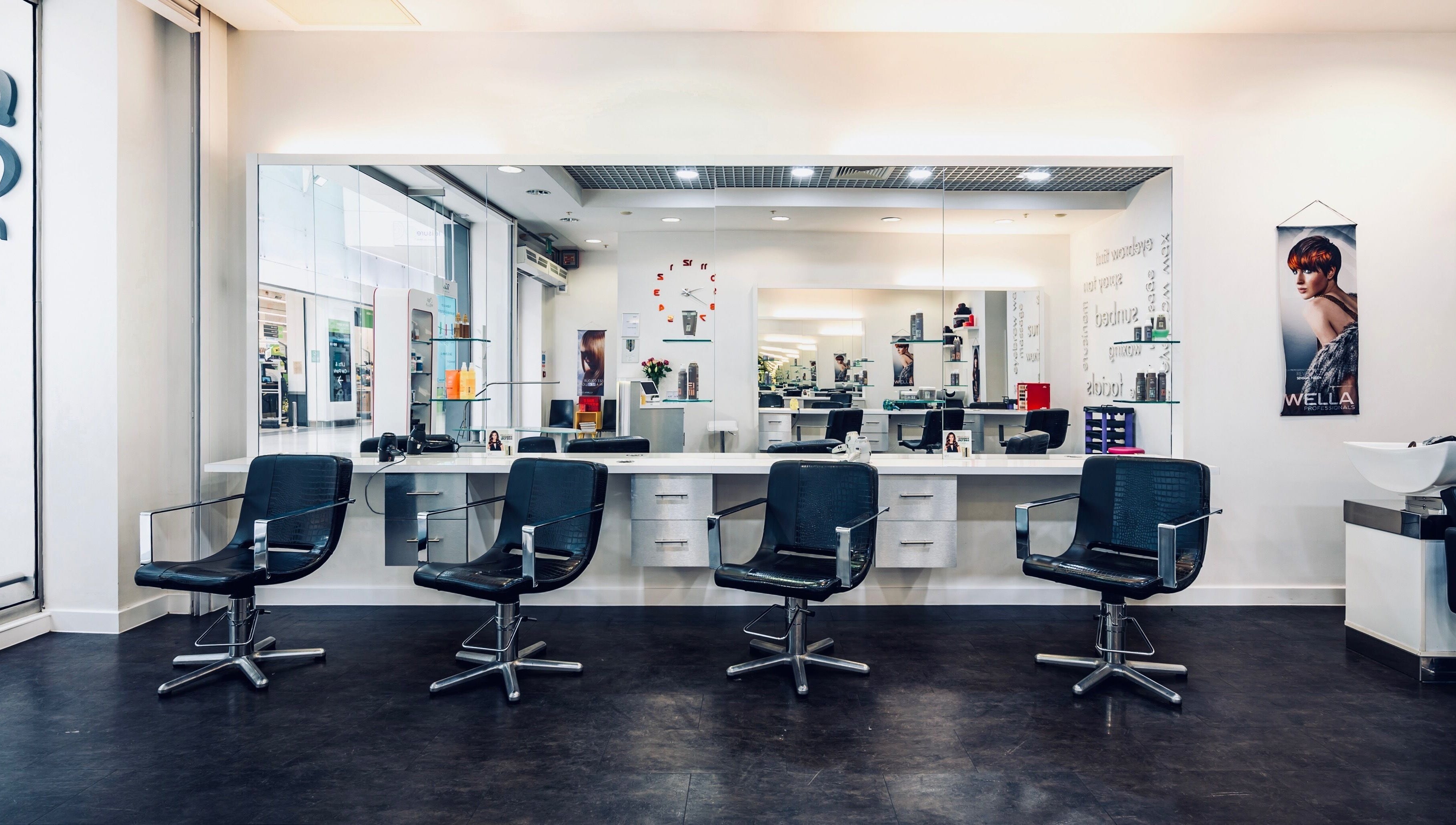 Modern salon chairs at Vida Hair & Beauty The Mercury in Romford, England, GB with sleek mirrors and decor.