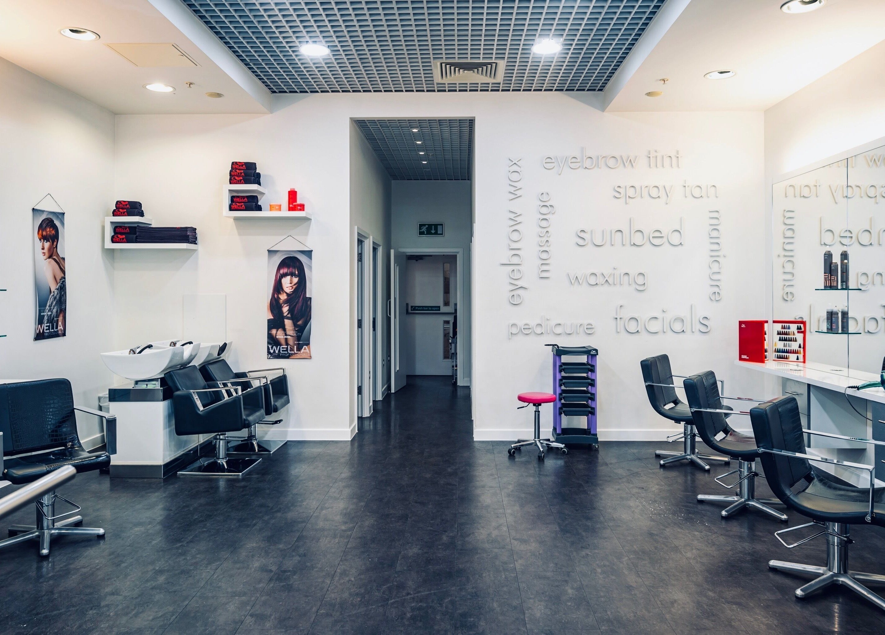 Modern interior of Vida Hair & Beauty The Mercury in Romford, England, GB with sleek styling chairs and mirrors.