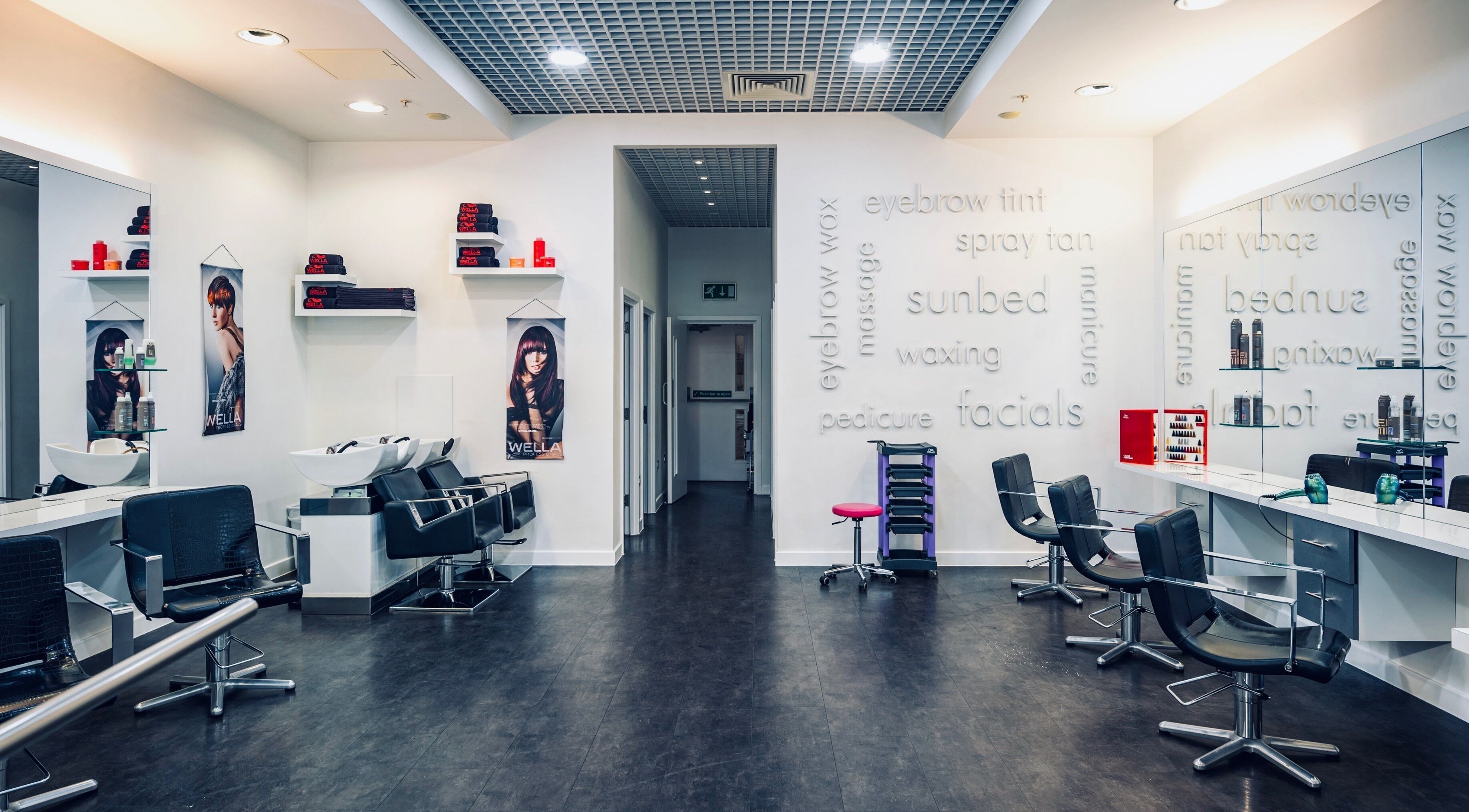 Modern interior of Vida Hair & Beauty The Mercury in Romford, England, GB with sleek styling chairs and mirrors.