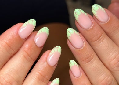 Stylish green floral-tipped nails at Cara Jade Beauty in Wells, England, GB.