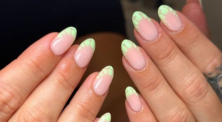 Stylish green floral-tipped nails at Cara Jade Beauty in Wells, England, GB.