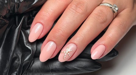 Elegant nail art at Cara Jade Beauty in Wells, England, GB featuring pink polish and star embellishment.