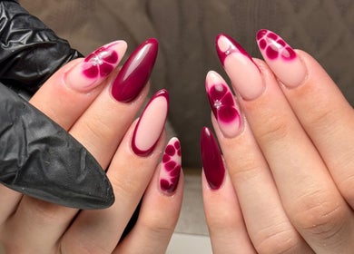 Elegant floral nail art at Cara Jade Beauty, Wells, England, GB featuring rich burgundy tones.