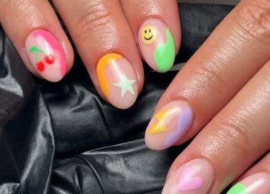 Colorful nail art featuring cherries and stars at Cara Jade Beauty in Wells, England, GB.