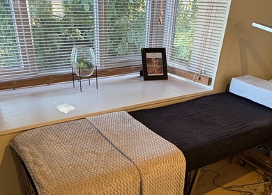 Relaxing treatment room at By Sophie Louise in London Colney, England, GB with a cozy massage table and calming decor.
