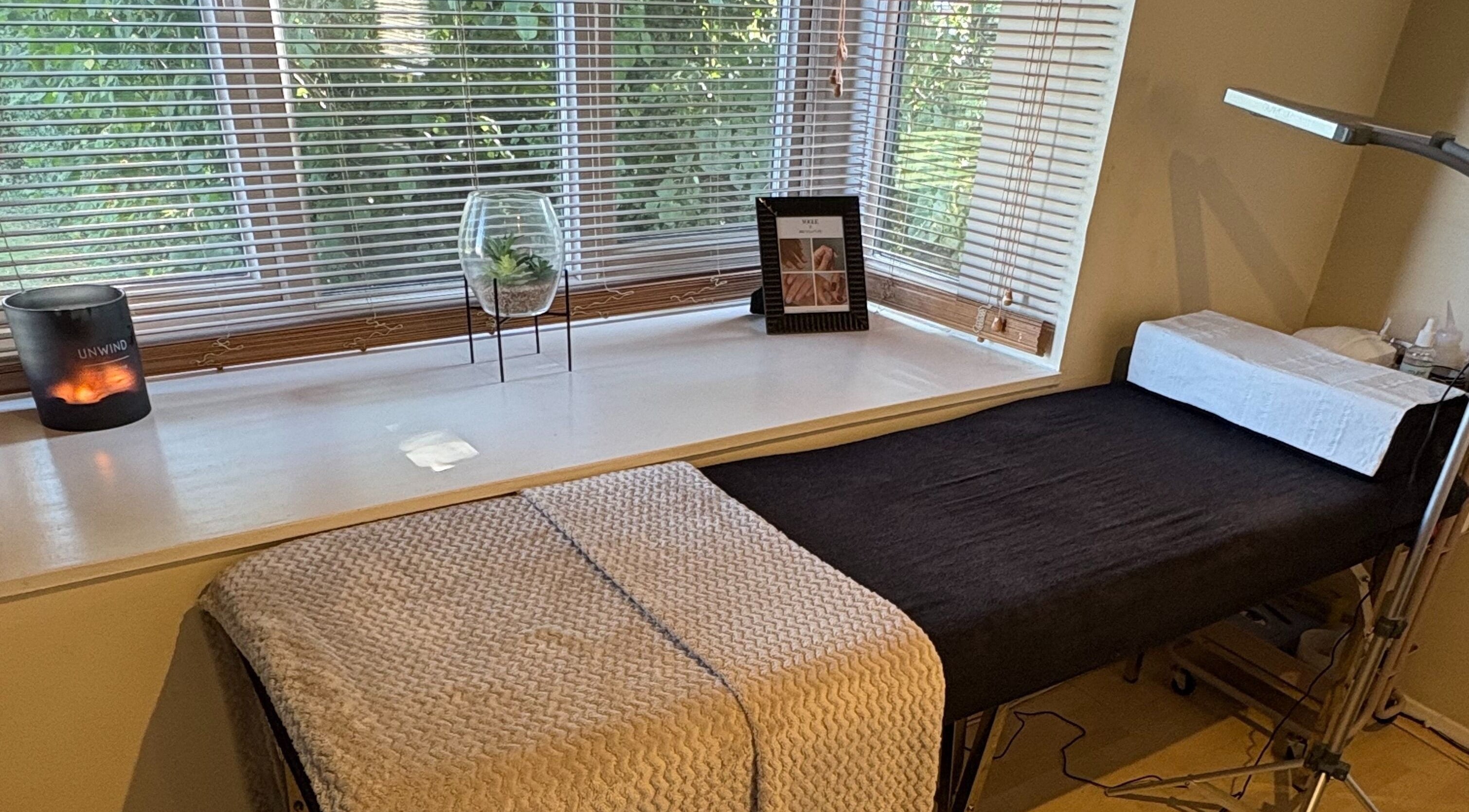 Relaxing treatment room at By Sophie Louise in London Colney, England, GB with a cozy massage table and calming decor.