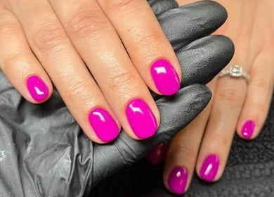 Bright pink nails with a glossy finish at By Sophie Louise, London Colney, England, GB.