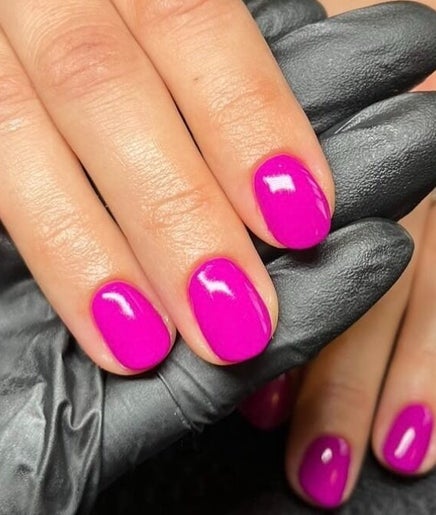 Bright pink nails with a glossy finish at By Sophie Louise, London Colney, England, GB.