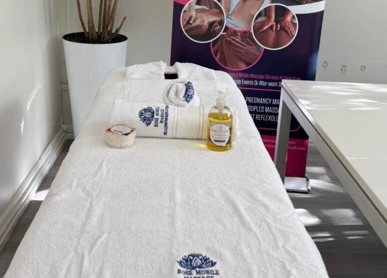 Massage table at Rose Mobile Massage in Cape Town, Western Cape, ZA, with oils and towels displayed.