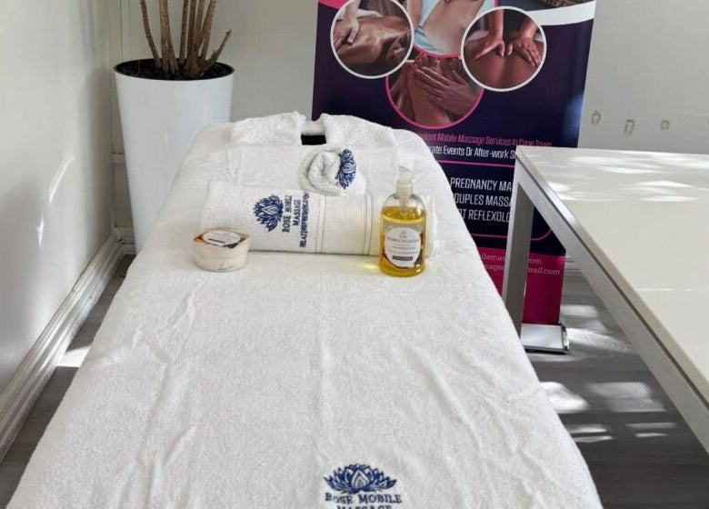 Massage table at Rose Mobile Massage in Cape Town, Western Cape, ZA, with oils and towels displayed.