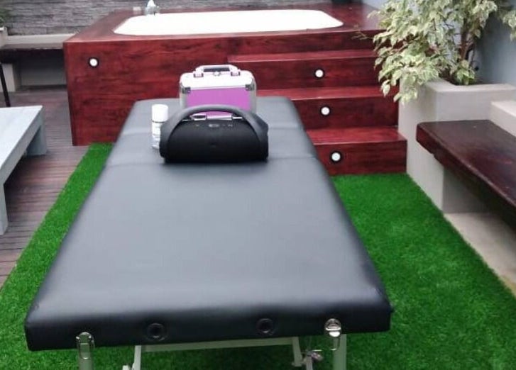 Luxurious outdoor massage setup at Rose Mobile Massage, Cape Town, Western Cape, ZA, with jacuzzi and greenery.