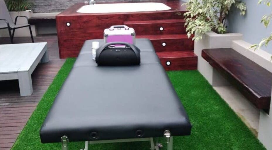 Luxurious outdoor massage setup at Rose Mobile Massage, Cape Town, Western Cape, ZA, with jacuzzi and greenery.