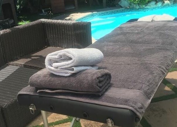 Massage table by the pool at Rose Mobile Massage, Cape Town, Western Cape, ZA.