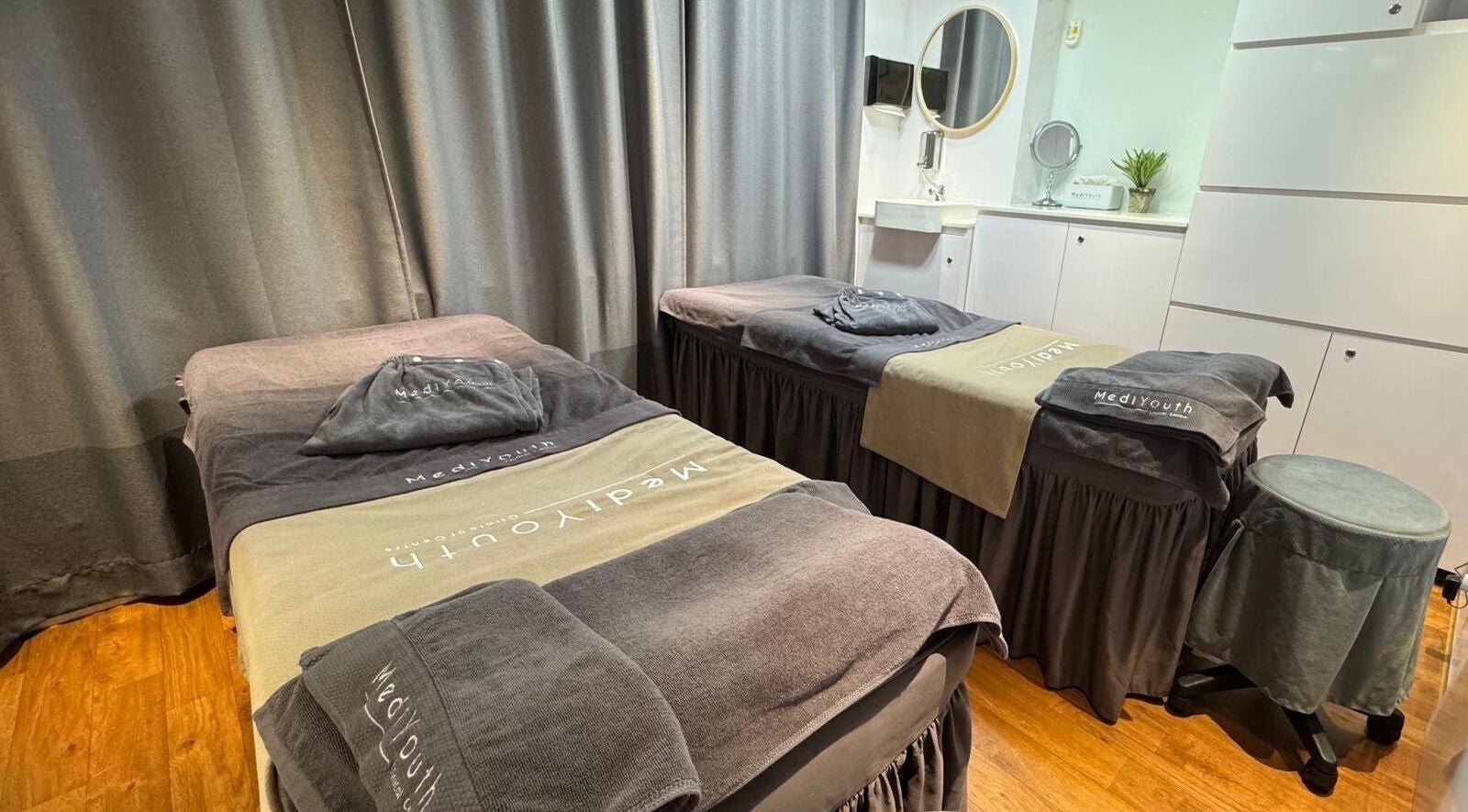 Relaxing treatment suite at Medi Youth Clinical Centre, Hong Kong Island, HK. Cozy beds and modern décor.