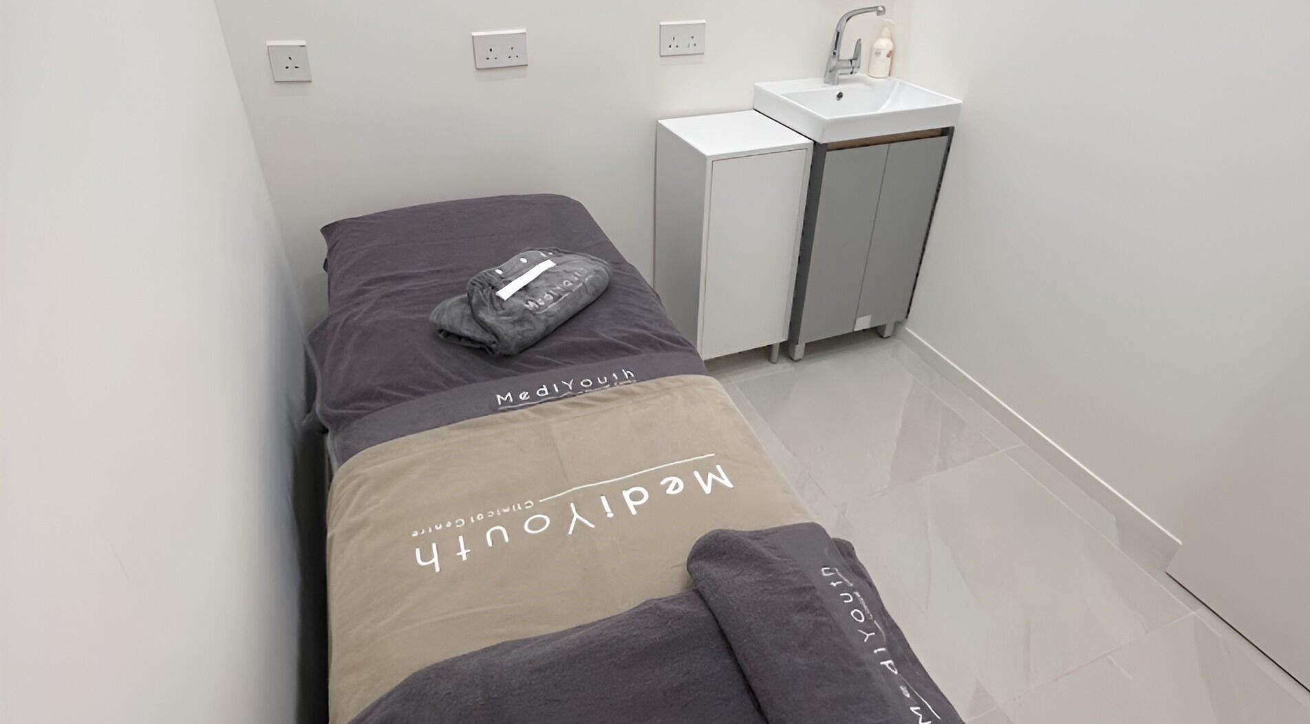 Tranquil treatment room at MediYouth Clinical Centre Central, Hong Kong Island, HK with plush bedding.
