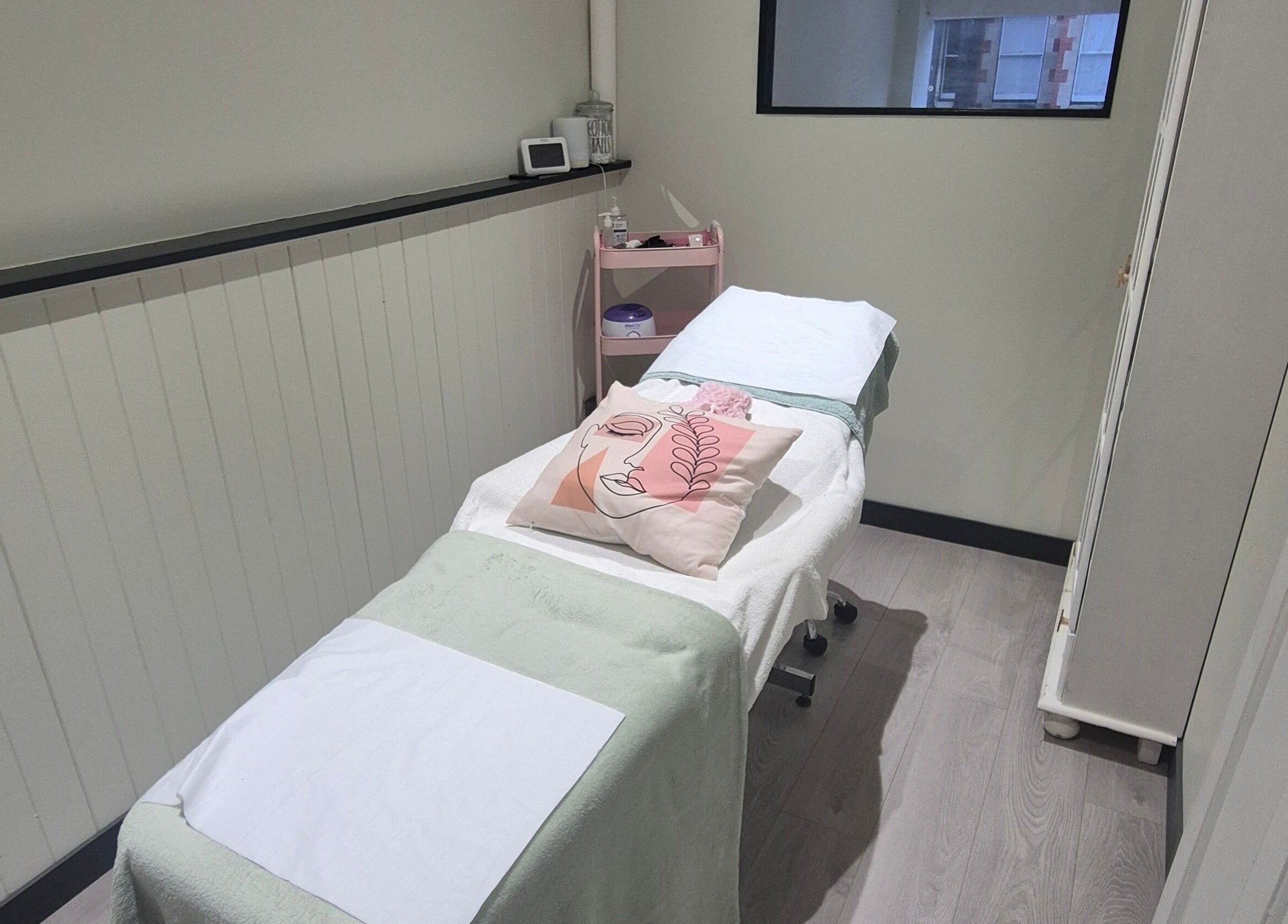 Cozy treatment room at Salon De Lyla, Ludgershall, England, GB, featuring a plush massage bed and soft lighting.