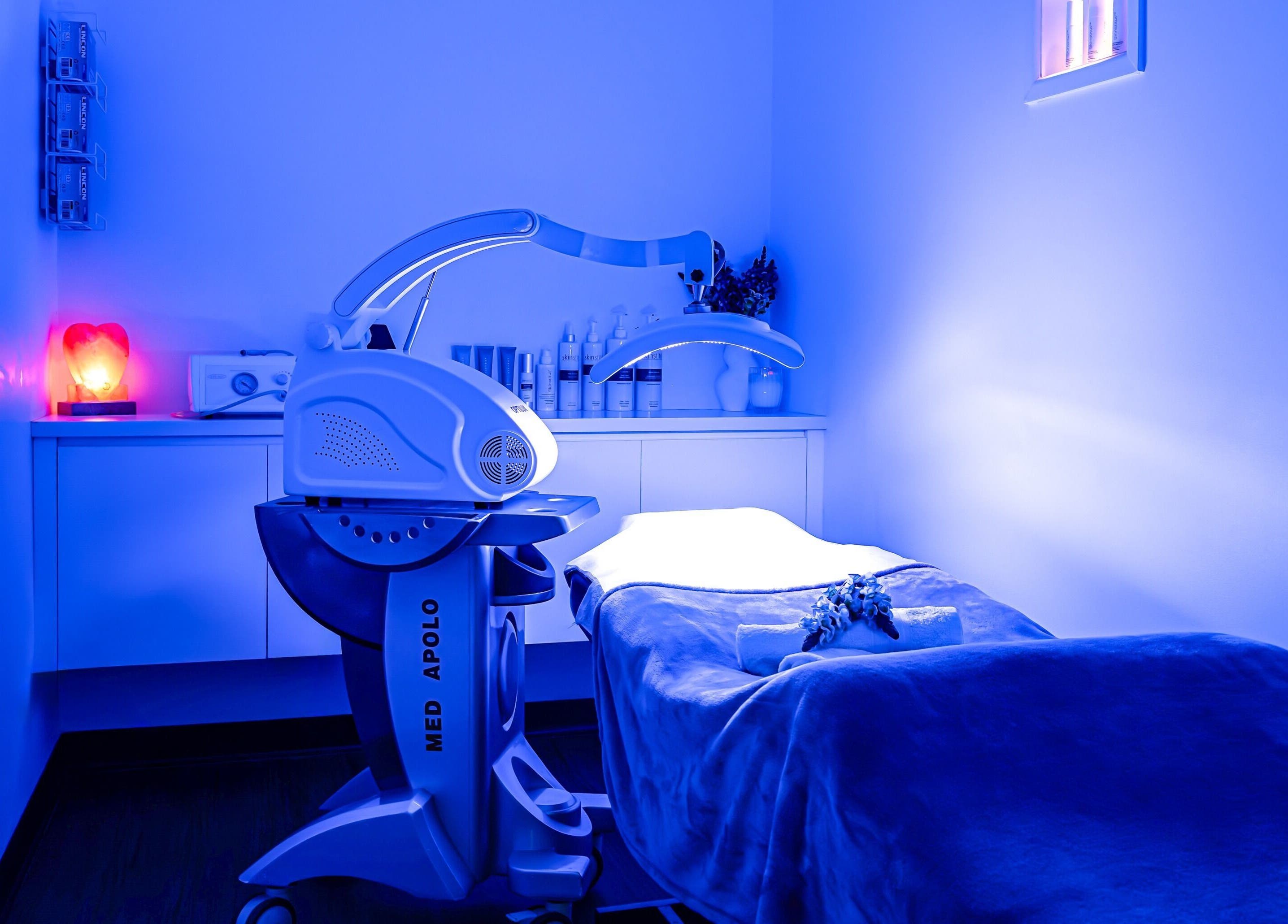 Tranquil treatment room at Face Magic Medispa, Coolangatta, Queensland, AU, with modern equipment and soothing blue light.